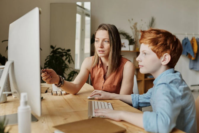 A boy is using a PC
