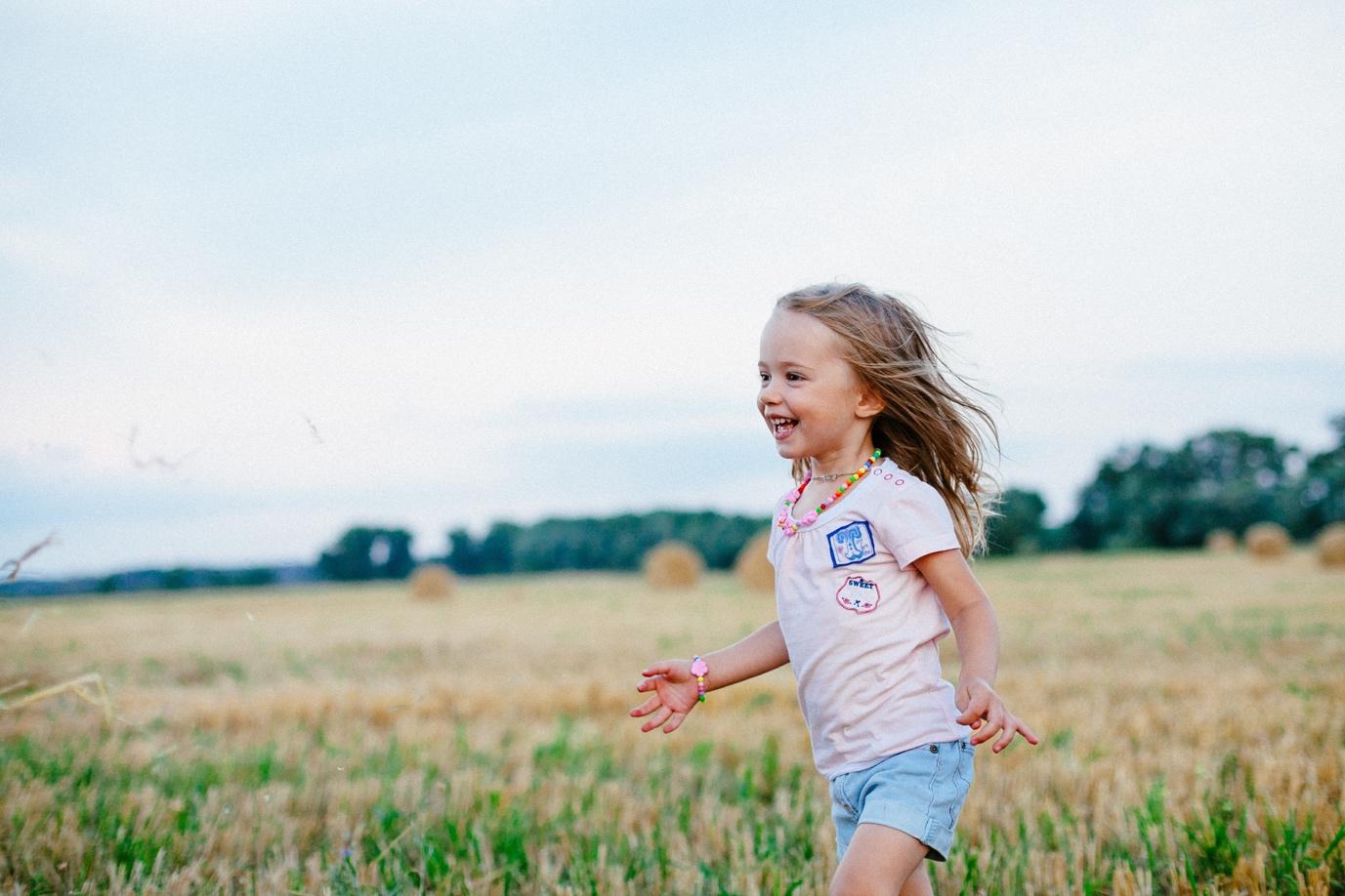 A young child running in a field

Description automatically generated with medium confidence