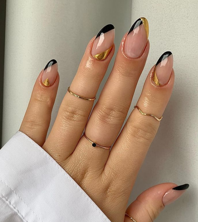 Adorable oval tip with black and gold nail design