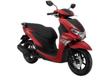A red motorcycle with a black backgroundDescription automatically generated with low confidence