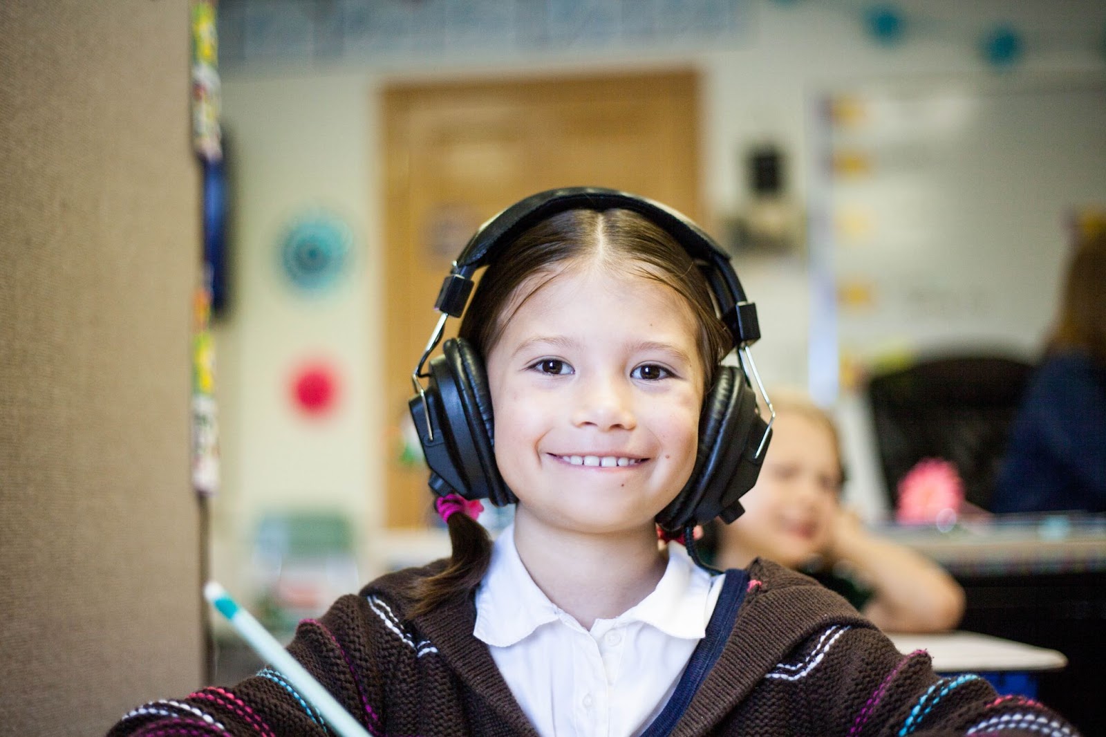 child smiling with headphones on