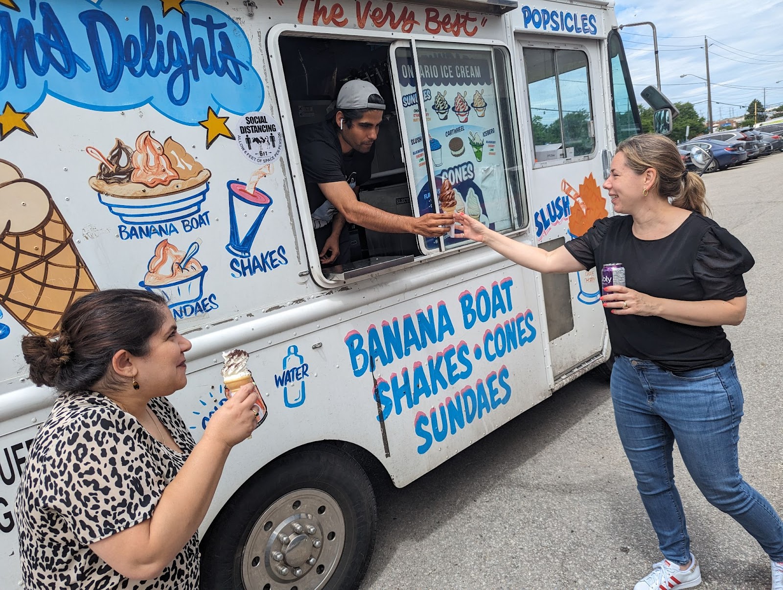 Elite Digital employee grabbing an ice cream cone from an ice cream truck. 