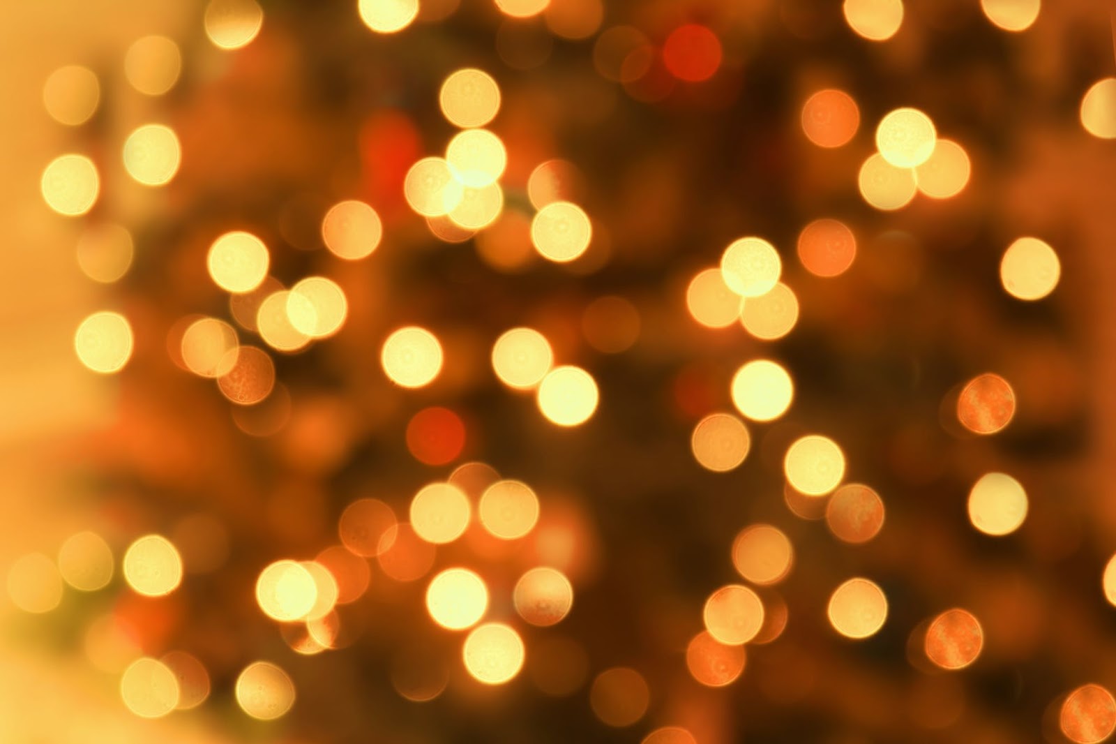 Defocused selection of Christmas lights glowing amber and gold
