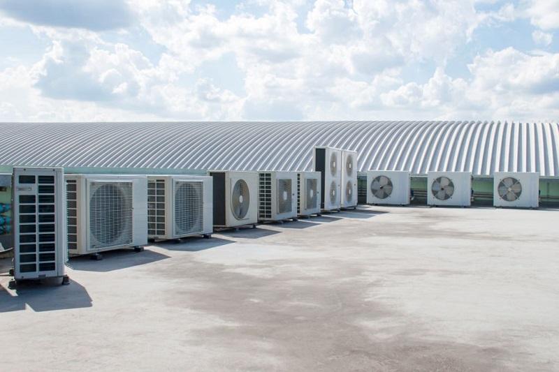 A group of air conditioners outside of a building Description automatically generated