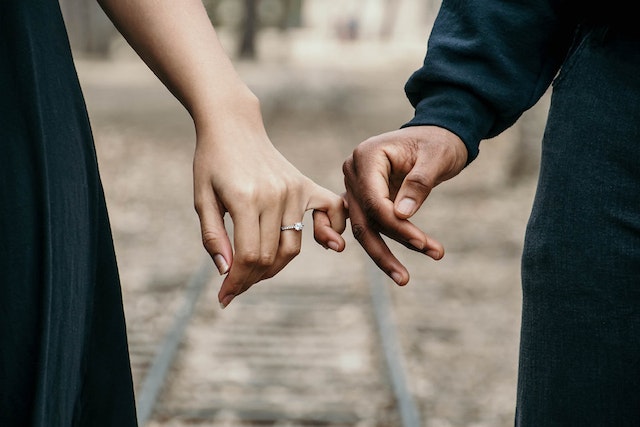 A newly engaged couple holding each other's hands on their proposal photoshoot in Sydney