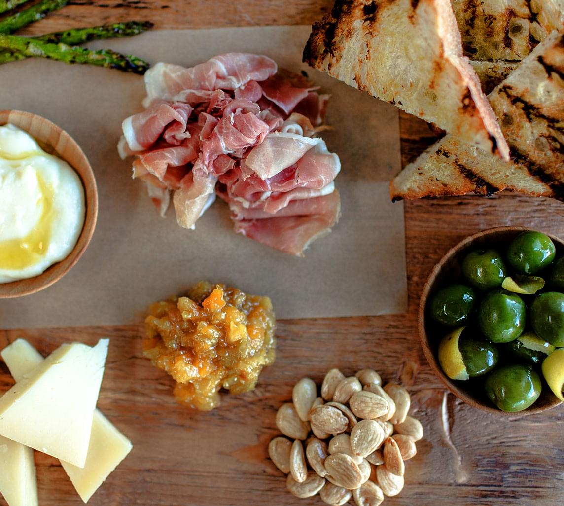 Charcuterie fixings on a wooden platter, served at North Italia in Denver's Cherry Creek neighborhood. 