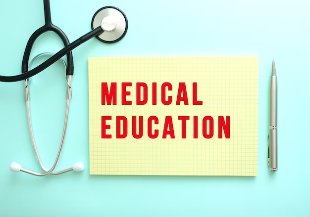 "Medical Education" written on a notepad beside a stethoscope on blue background.