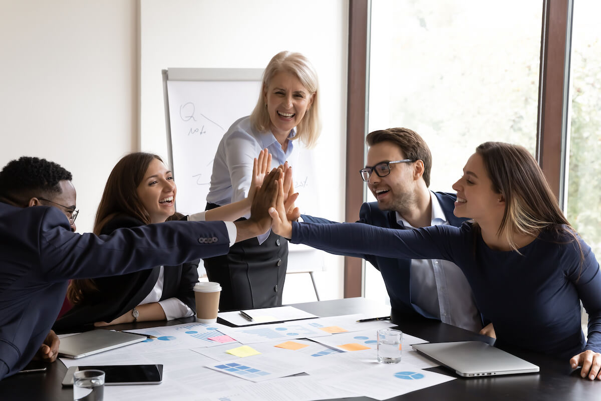 EHR interoperability: happy team putting their hands together