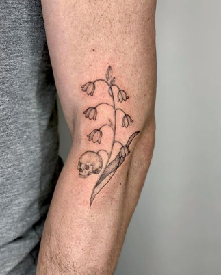 Skull In Lily Of The Valley Tattoo