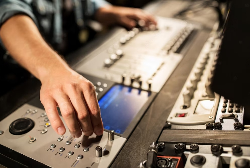 side view of man using mixing console in sound recording studio