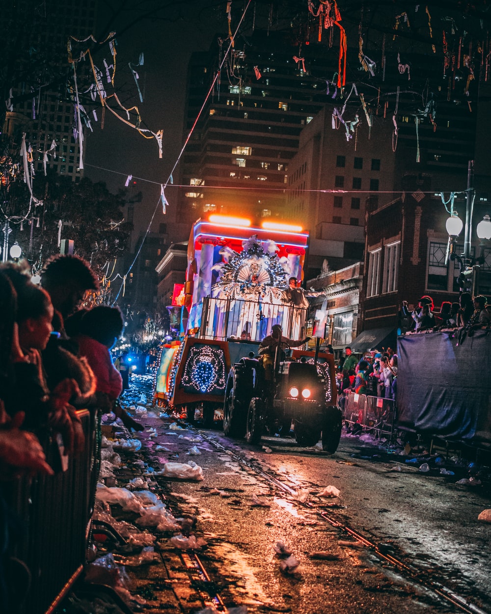 person riding on tractor surrounded by peoples