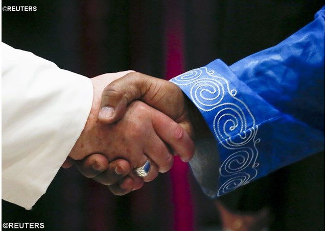 Pope Francis shakes hands with an Ambassador to the Holy See. - REUTERS