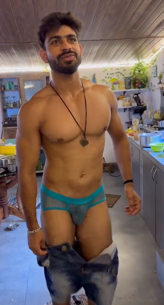 MasterJenny pulling down his jeans to reveal blue see through briefs while smiling at the camera