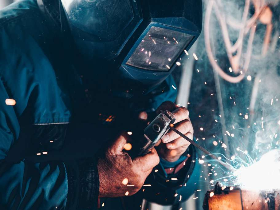 An ironworker holding an iron machine.