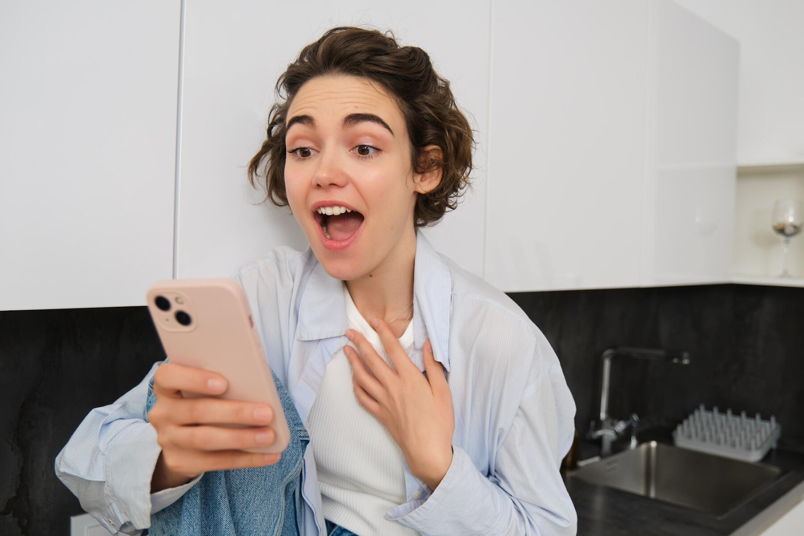 A woman surprised to see sarcastic Facebook statuses.