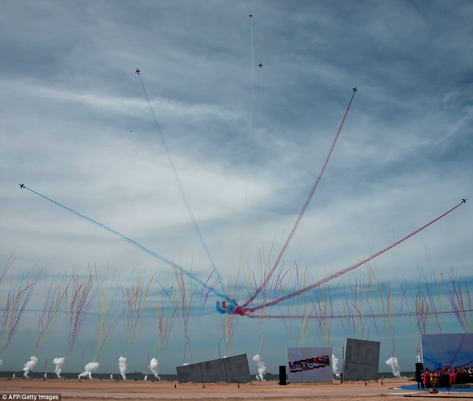 Troupe: Alpha jets, part of the Patrouille Acrobatique de France, leave trails of smoke in the colors of the French flag during the ceremony