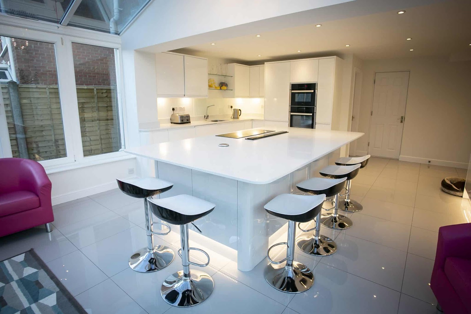 kitchen flooring ideas; a white kitchen with a massive kitchen island