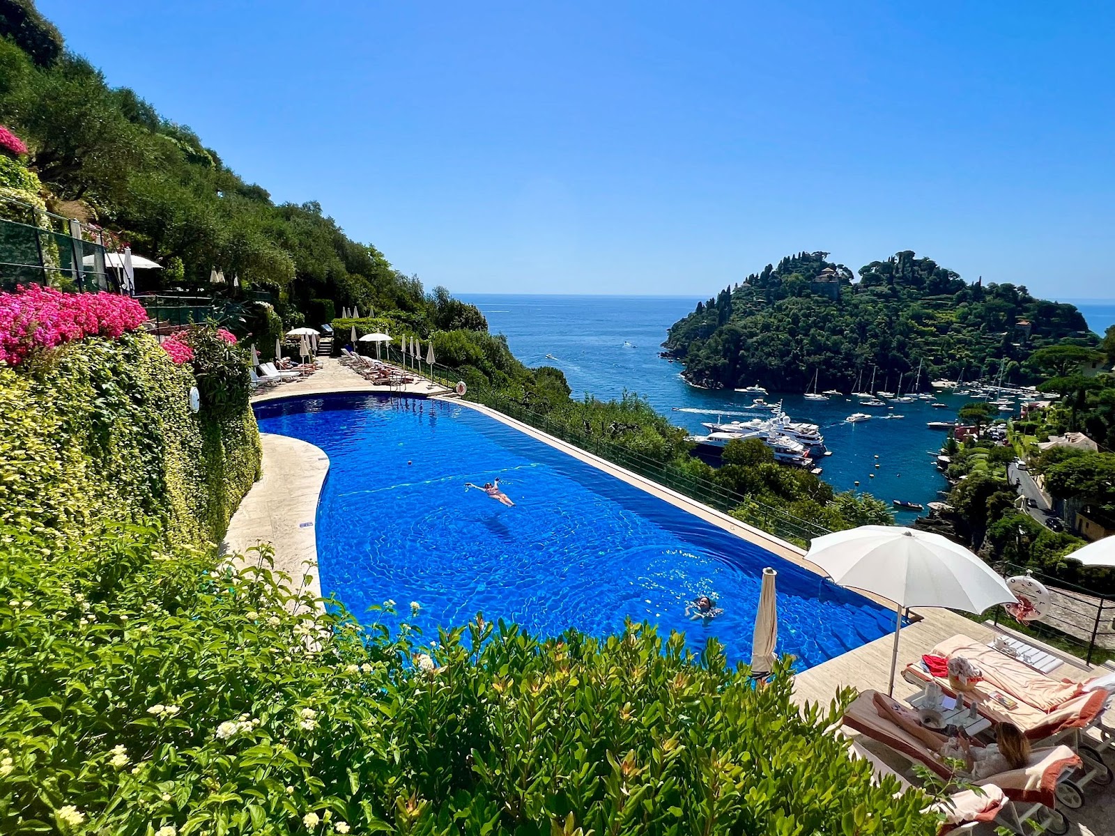 a pool with a body of water and trees with Marigot Bay in the background