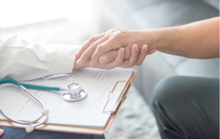 Doctor holding patient's hand