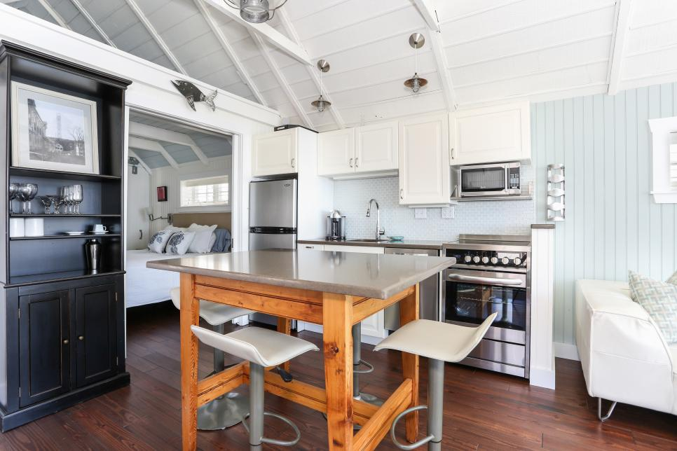 bright coastal kitchen with a 10 foot cabinet run, including stainless steel appliances. light blue wall paint and white ceilings make the room feel open and bright