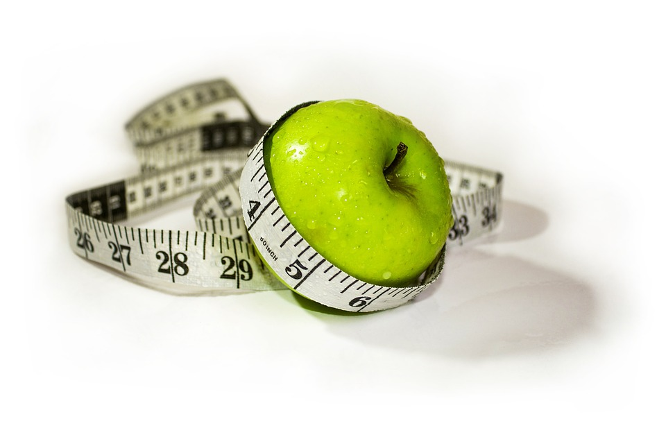 an apple covered with measuring tape