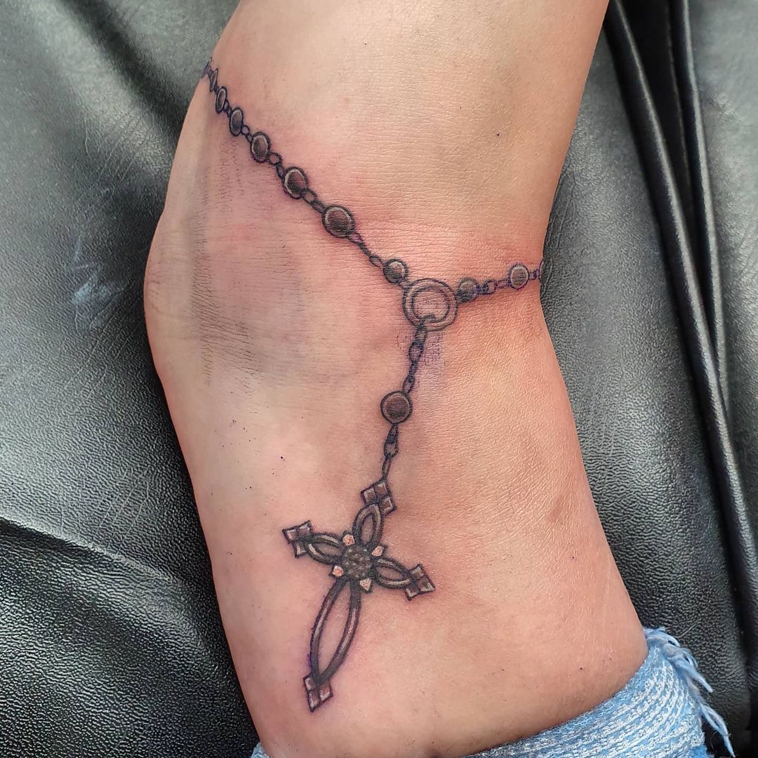 Cross tattoo with chain design