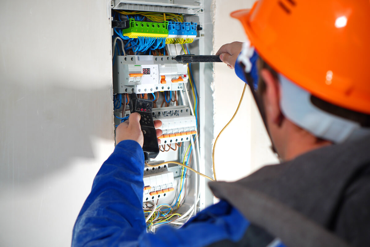 Safety procedures: electrician checking a circuit breaker