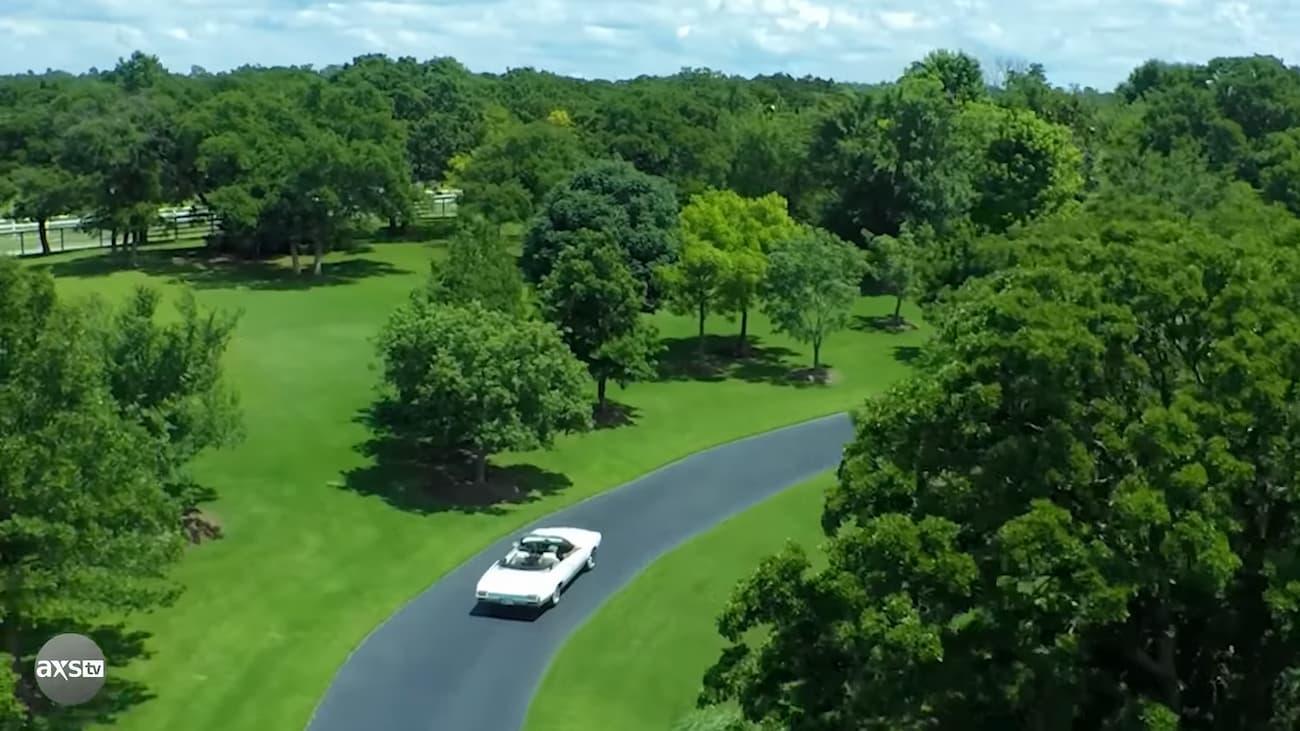 A car driving on a road surrounded by trees

Description automatically generated with medium confidence