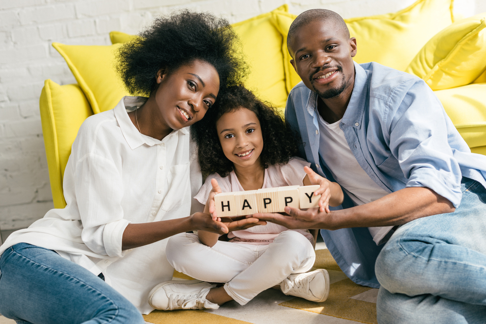 Family using blocks to spell out Adjectives For Kids