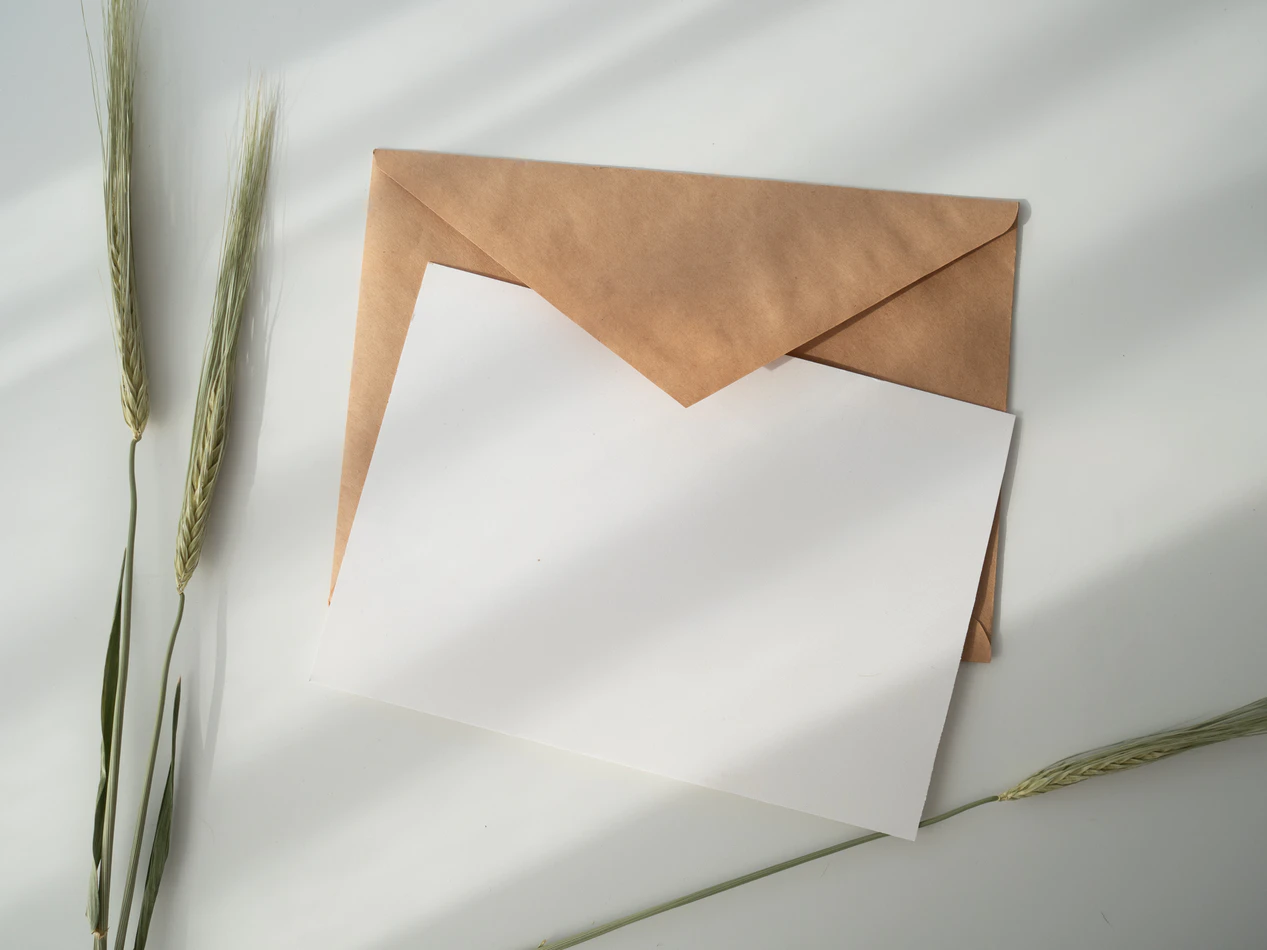A white card and brown envelope for an eco-friendly holiday gift.