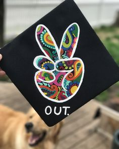 A graduation cap that reads "out."