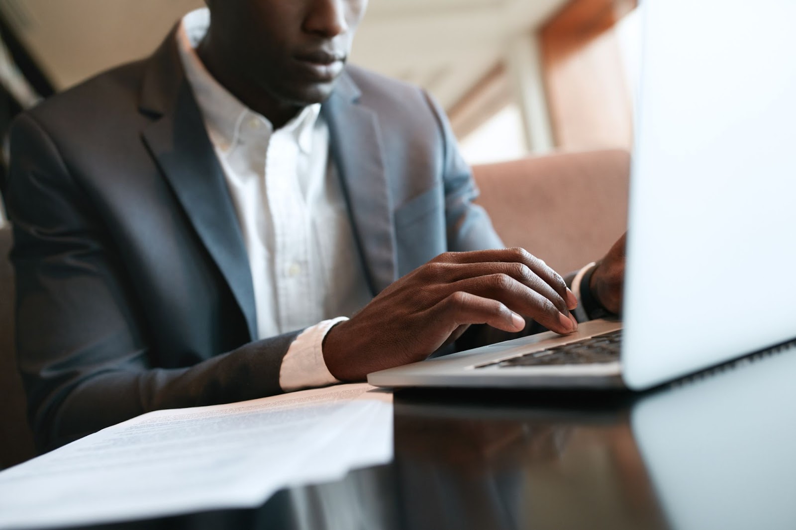 Close-up of male hands typing on a laptop