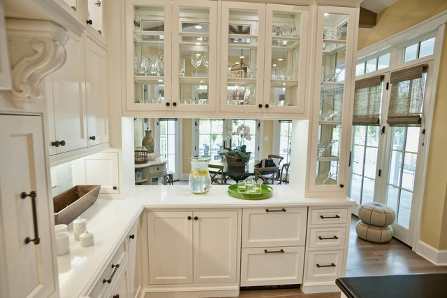 Classy, white cabinets with matte back hardware. white countertop. 