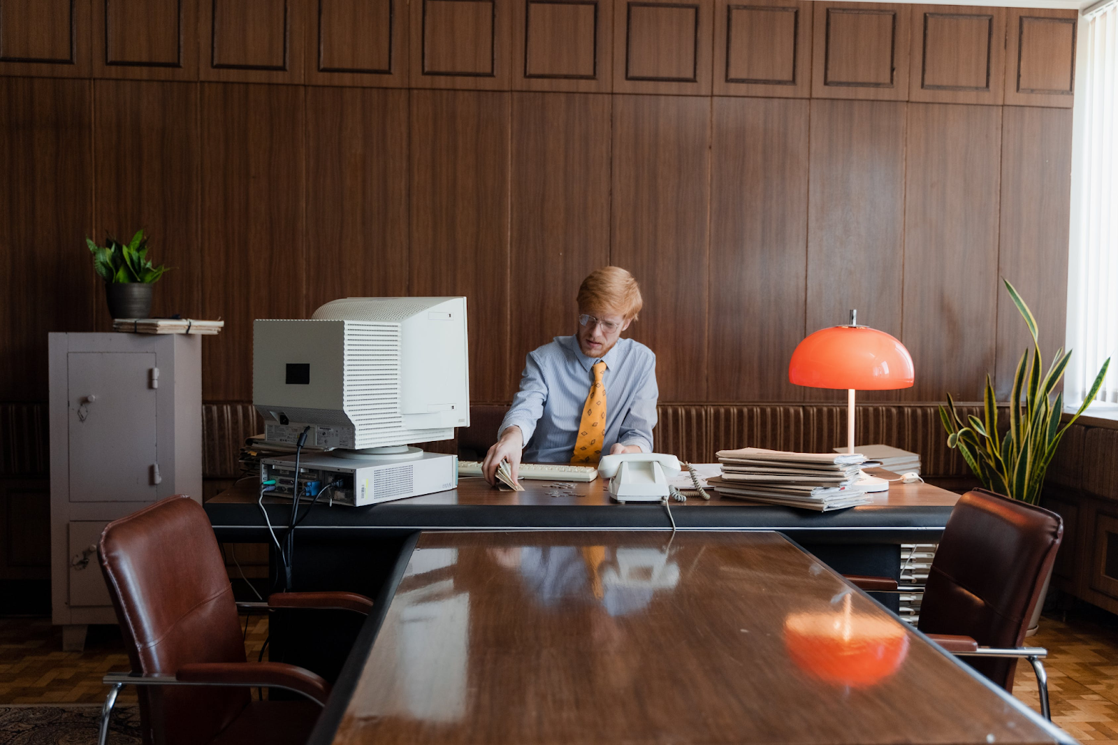 Man at desk with old computer