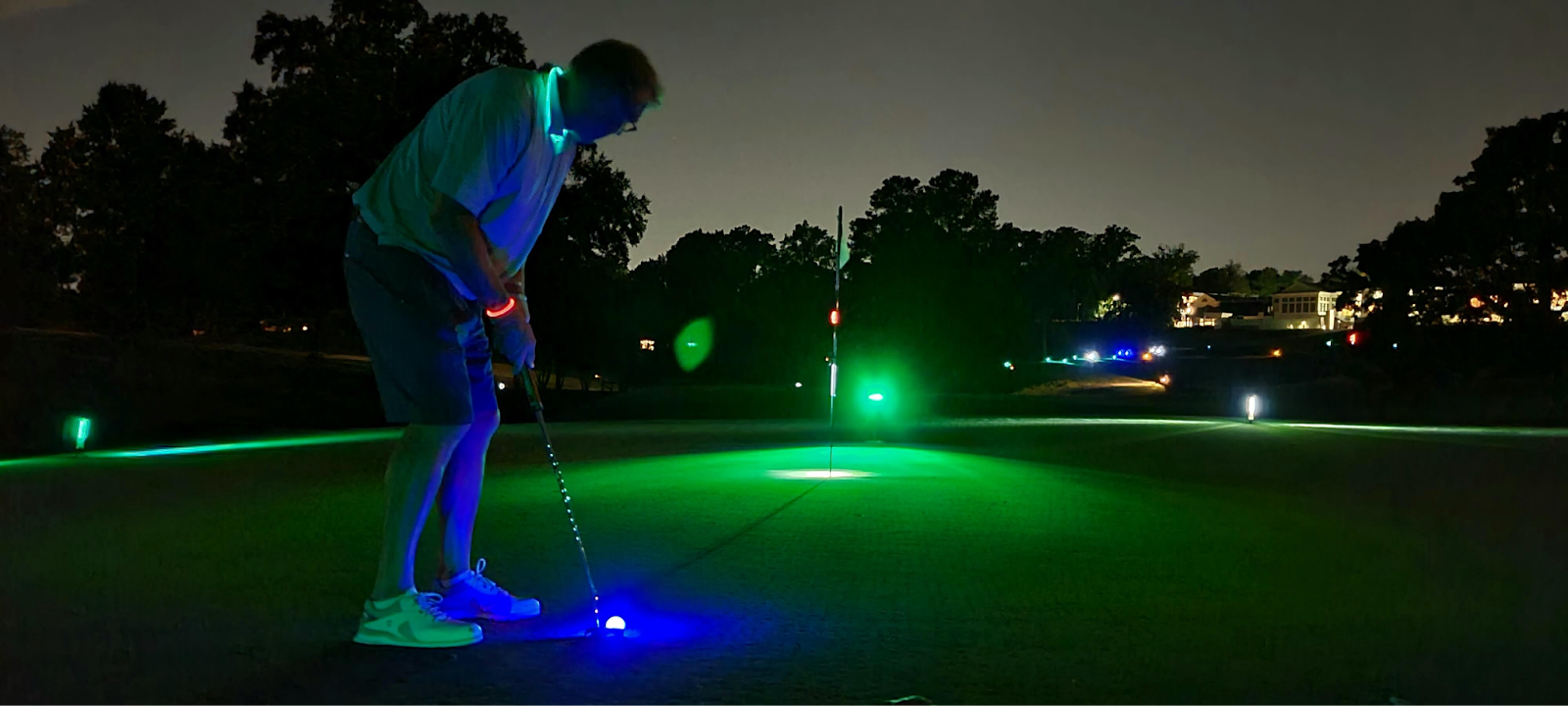 green and blue glow at night on golf course