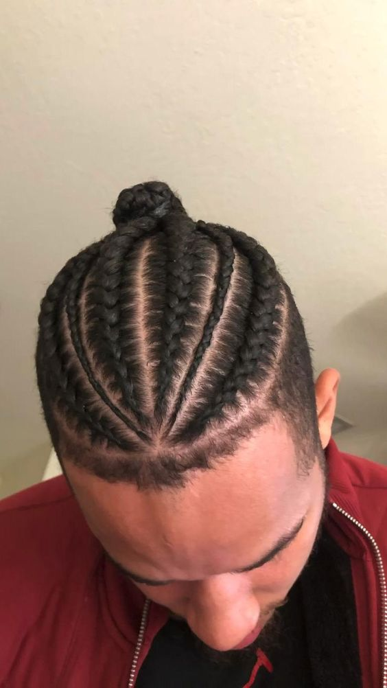 a guy showing off his braided man bun