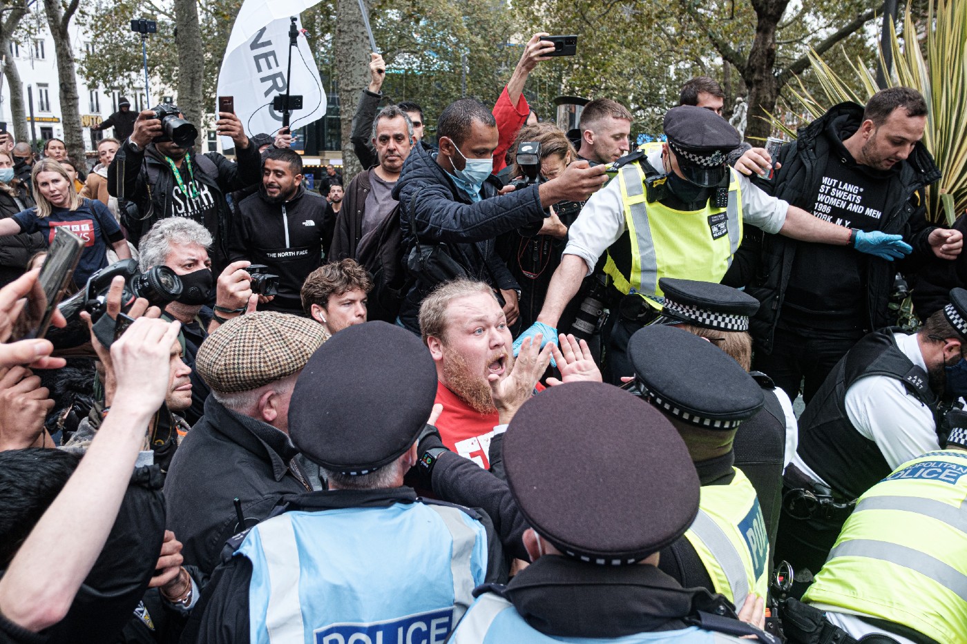 angry face in a crowd confronting police