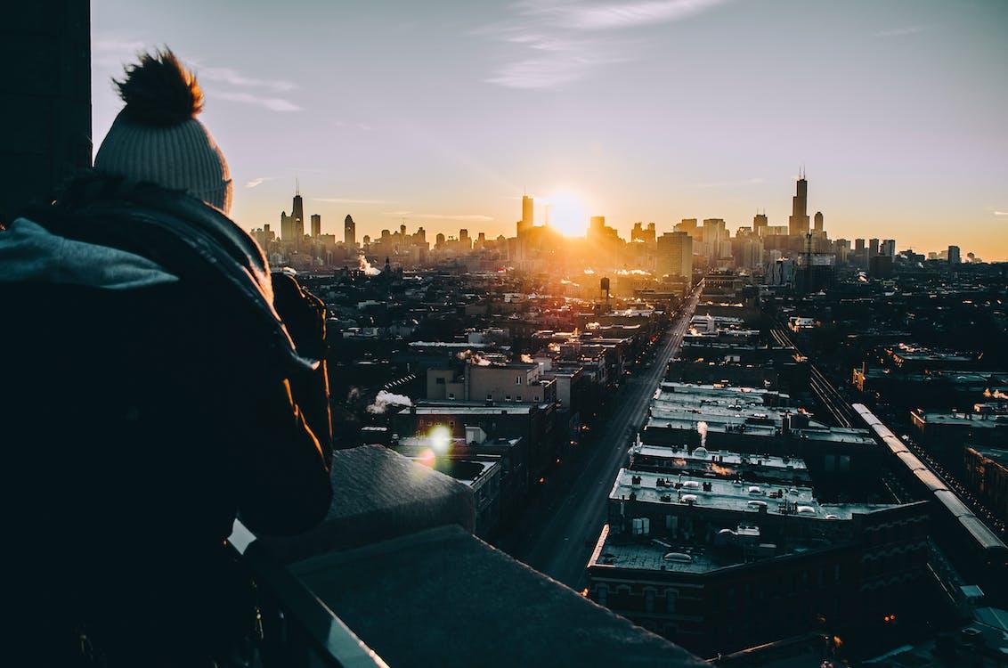 Free Man in Black Jacket Standing on Top of Building during Sunset Stock Photo
