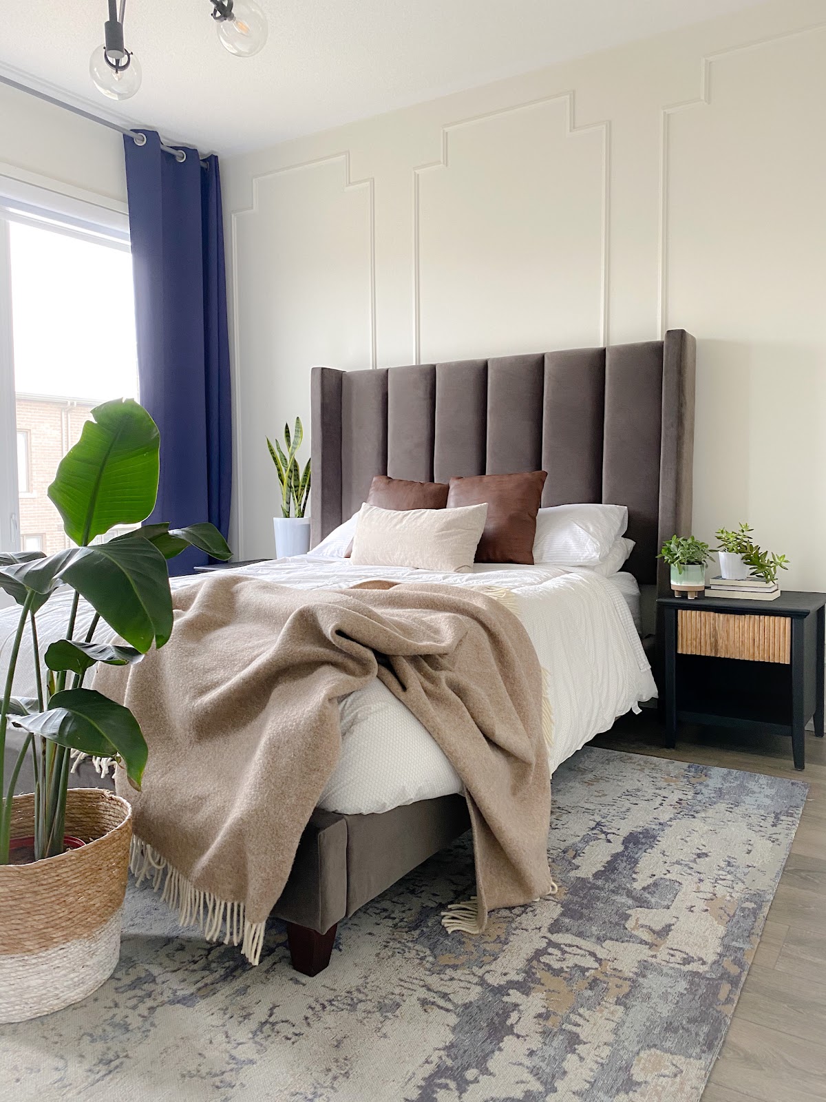 Bright bedroom with decorative molding
Grey headboard