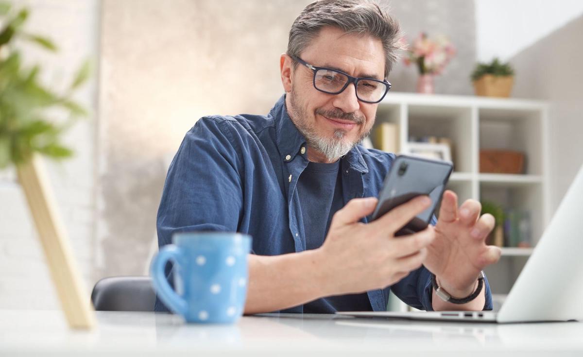 Patient support: man happily using his phone