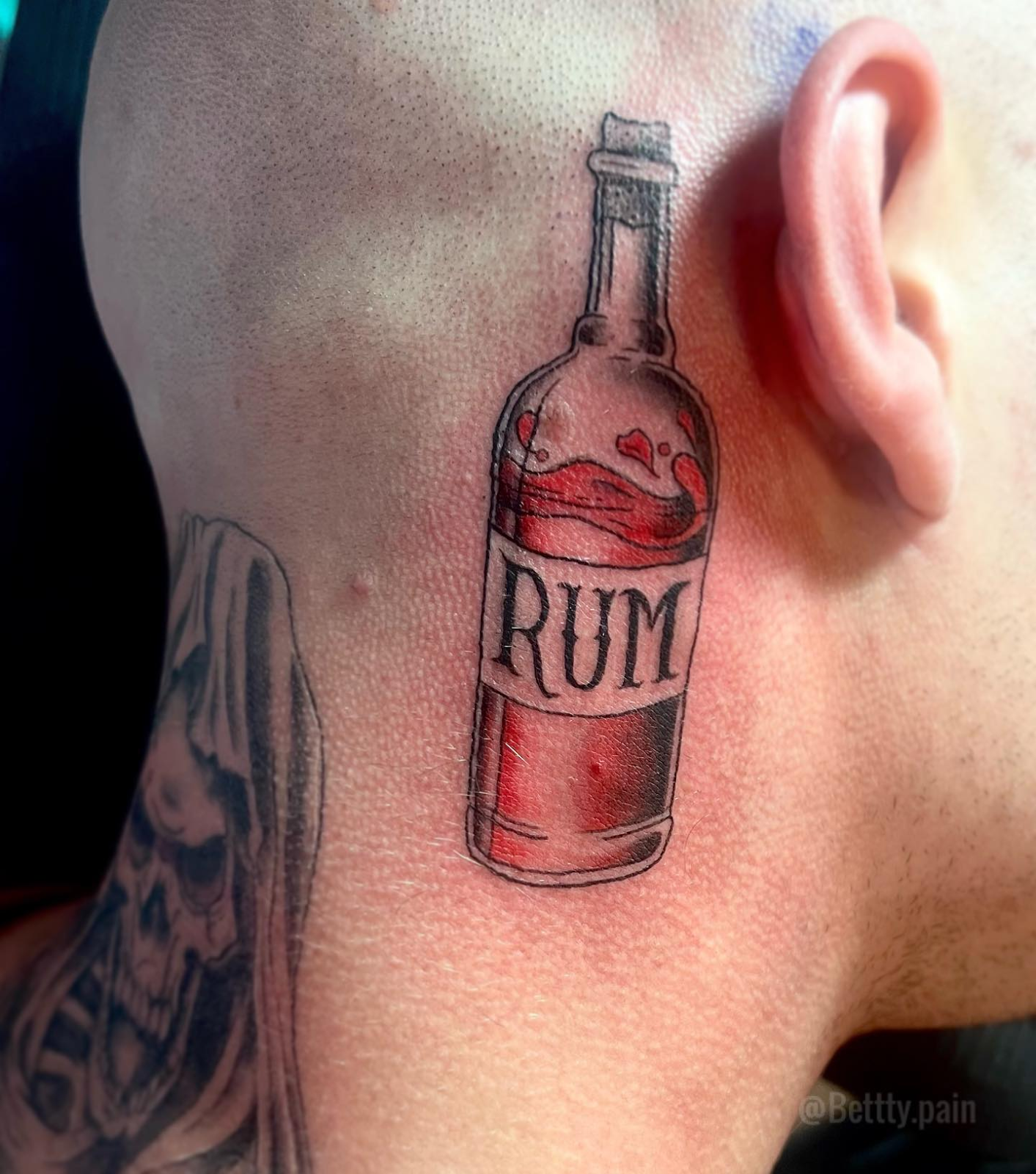 Rum Bottle Behind The Ear Tattoo