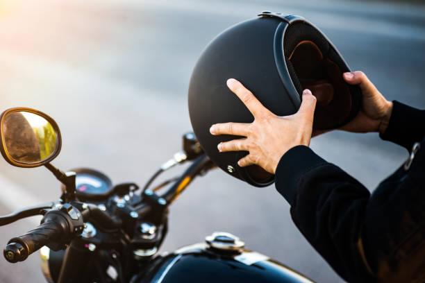 Motorcycle couple holding helmets in hands . Motorcycle couple holding helmets in hands . phone safety for motor riders stock pictures, royalty-free photos & images