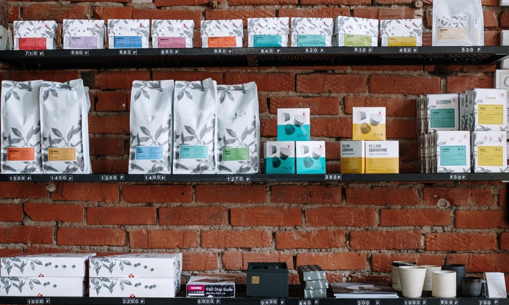Shelves stacked with a variety of coffee bags, pouches, and boxes.  