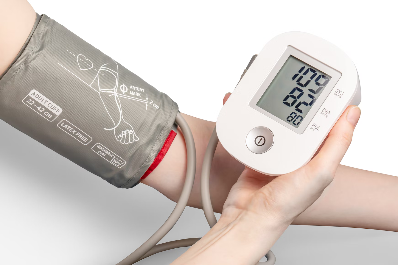 A person using a blood pressure monitor on their upper arm