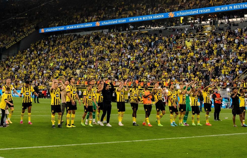 Borussia Dortmund players celebrate in front of the Yellow Wall 