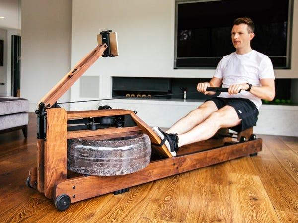 person using a water rower -- best rowing machines