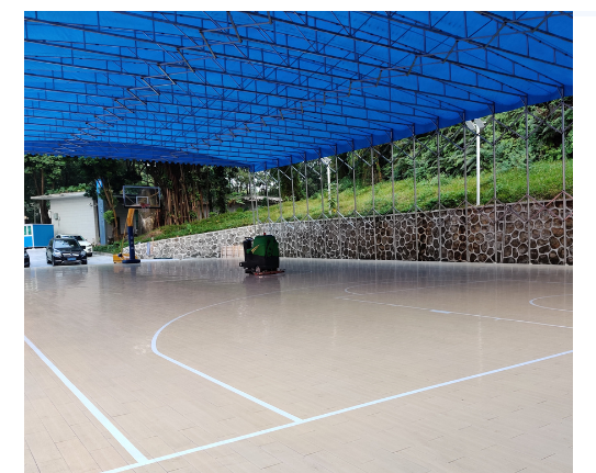 An outdoor basketball court with Macwood Flooring System