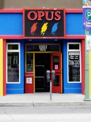 Outside view of Opus Art Supplies, a local Kelowna art store with a bright blue, red and yellow painted exterior