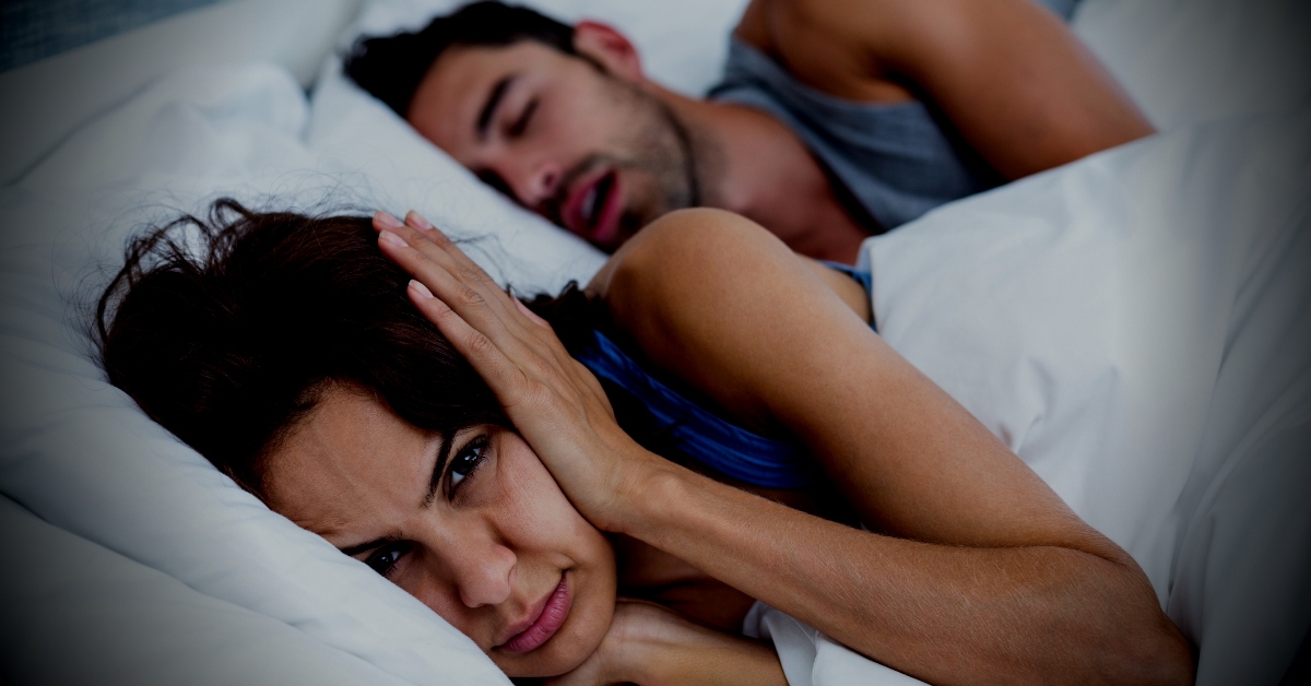 Man snoring disrupting partner's sleep - Slumber Hackers