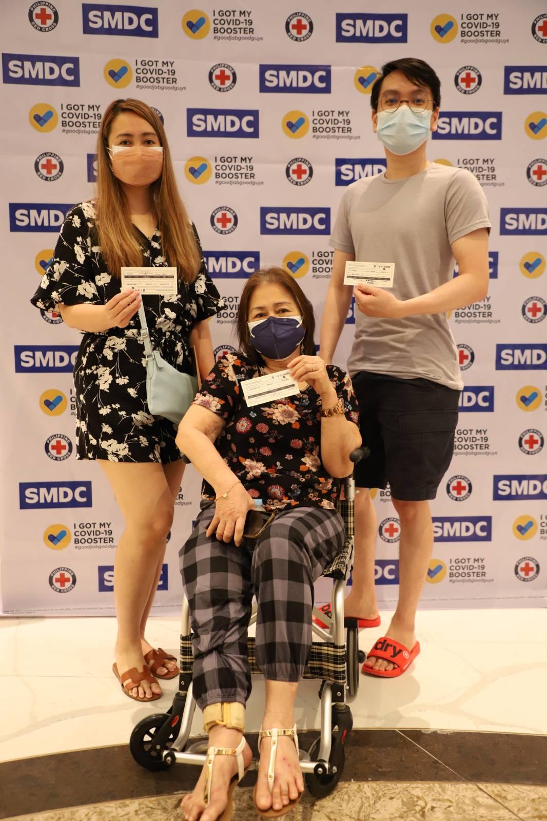 A woman in a wheelchair accompanied by a man and a woman